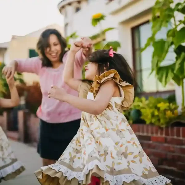 Mom dancing with her daughters on the street