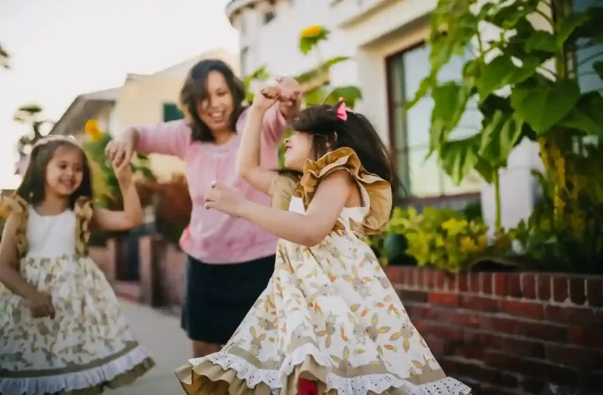 Mom dancing with her daughters on the street