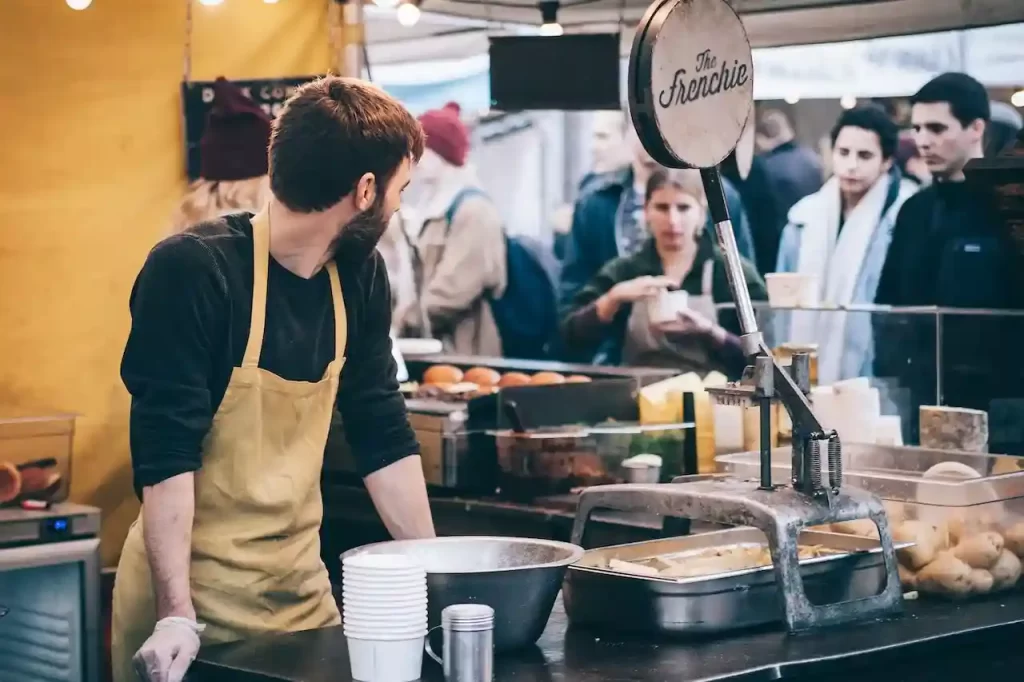 A man at an open kitchen in a fast food place