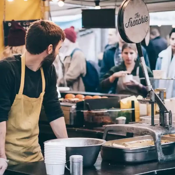 A man at an open kitchen in a fast food place