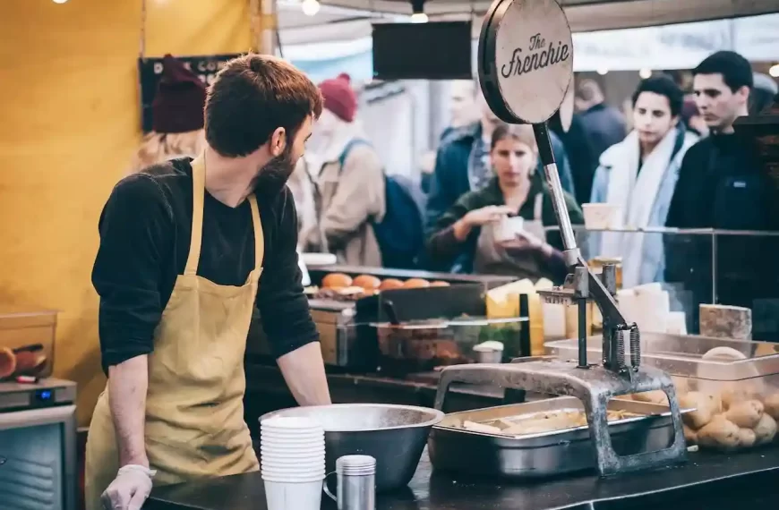 A man at an open kitchen in a fast food place