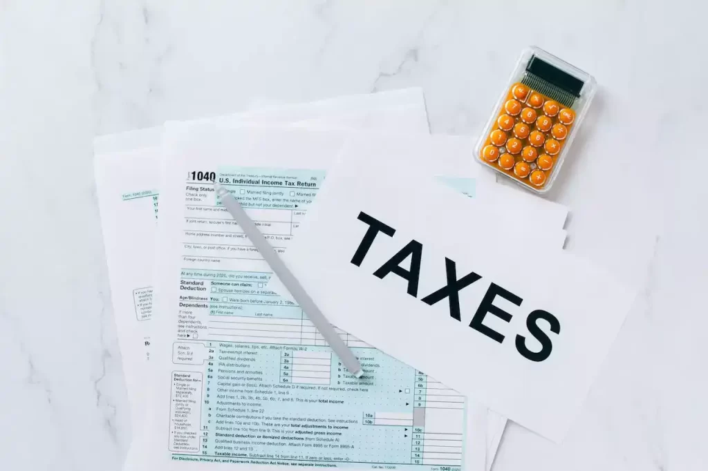 Tax documents on a table with a calculator