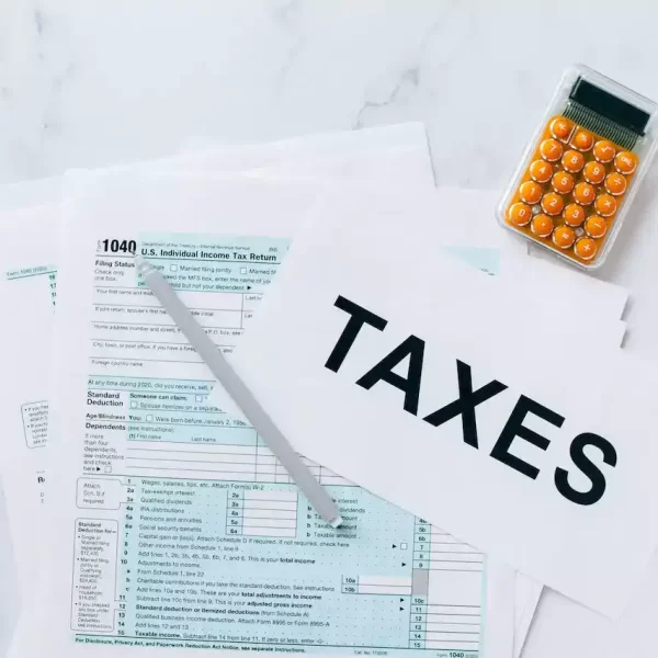 Tax documents on a table with a calculator