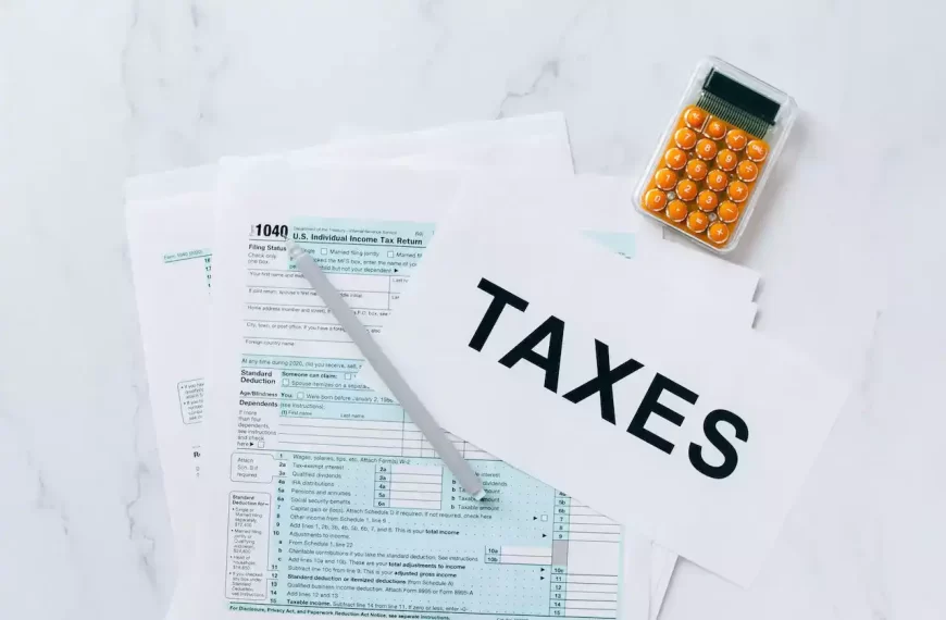 Tax documents on a table with a calculator