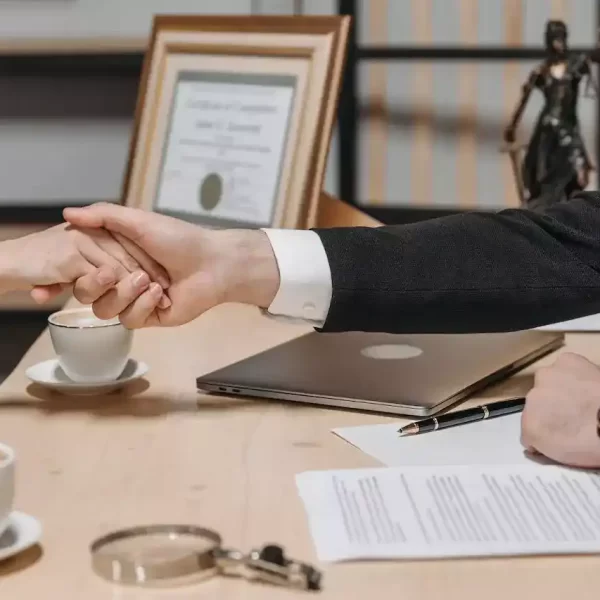 People shaking their hands in a lawyers office