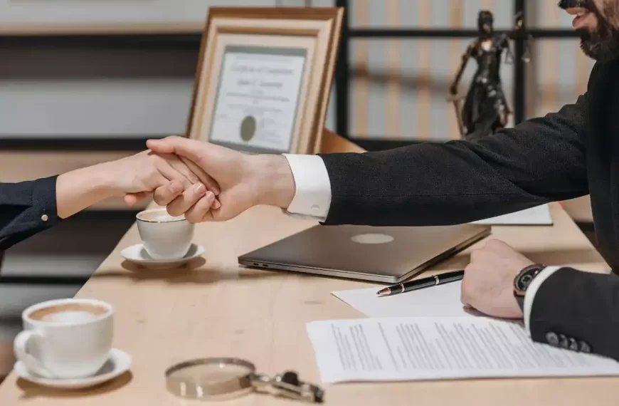 People shaking their hands in a lawyers office