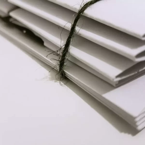 White paper folder with black string to keep them together