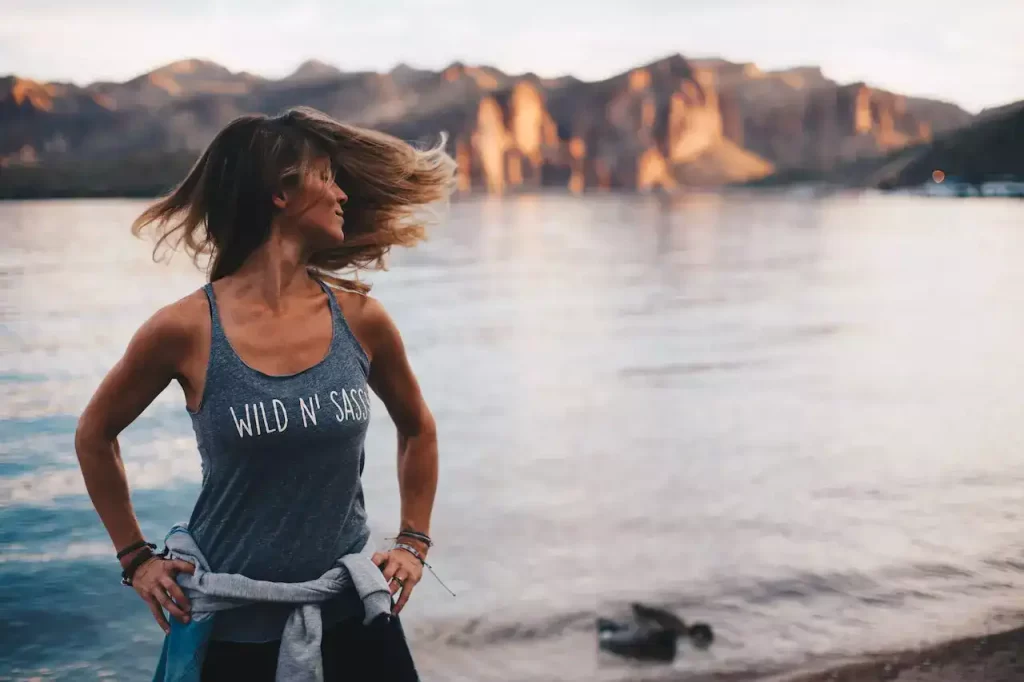 a woman in a "wild and sassy" t-shirt flinging her hair happily