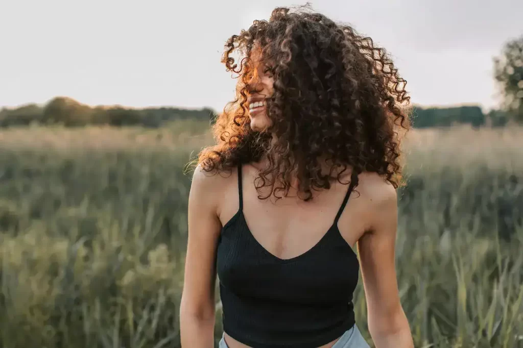 A woman smiling in a field