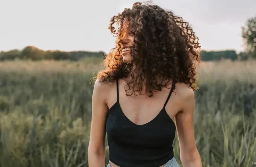 A woman smiling in a field