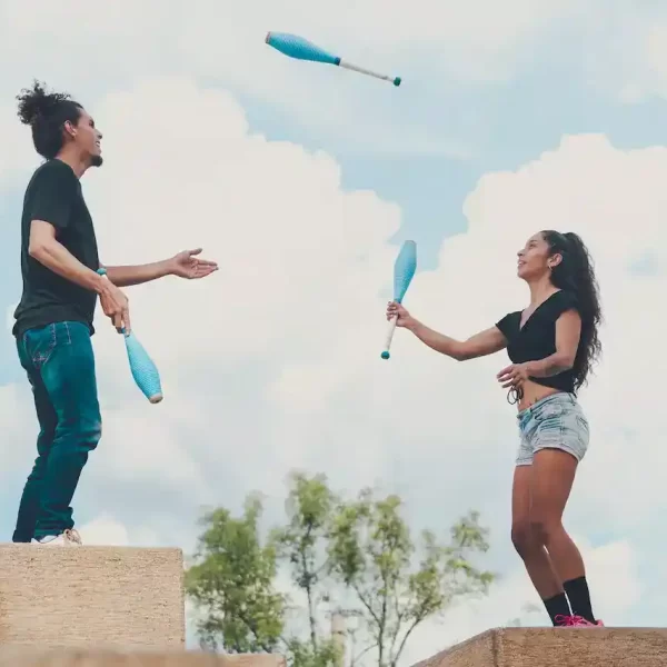 A man and a woman juggling together