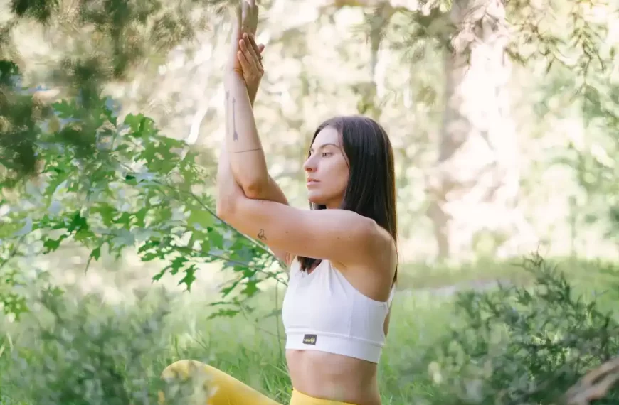 A woman doing yoga around plants