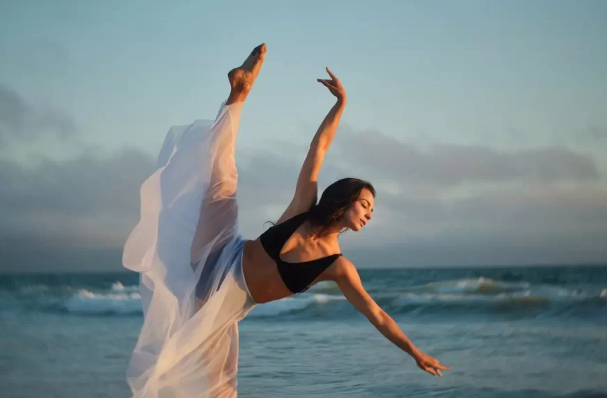 A slender dancer performing on coast of ocean with passion